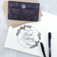 Letterpress printed card with brush lettering and an envelope on a textured surface.